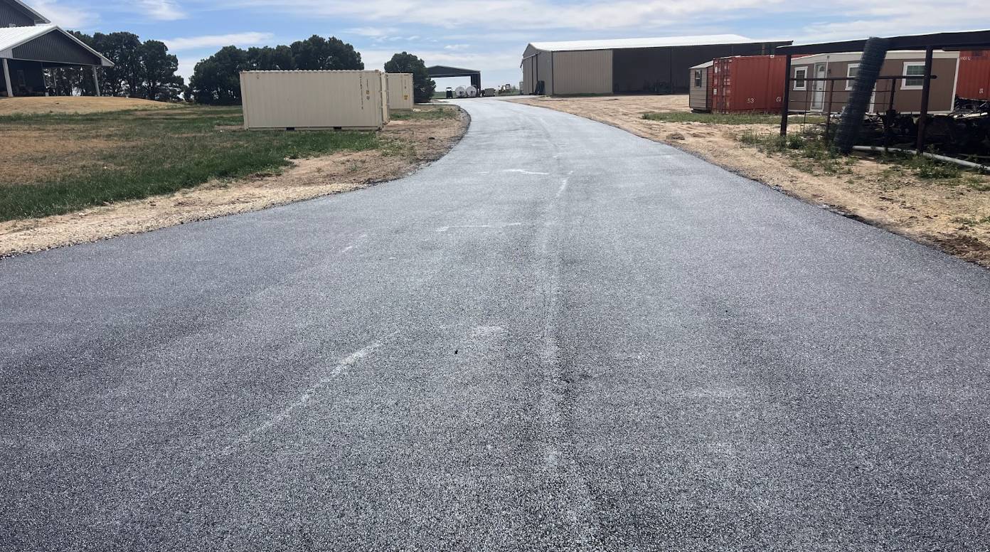 Durable recycled asphalt access road installation for a commercial property in Big Spring Texas by Permian Paving.